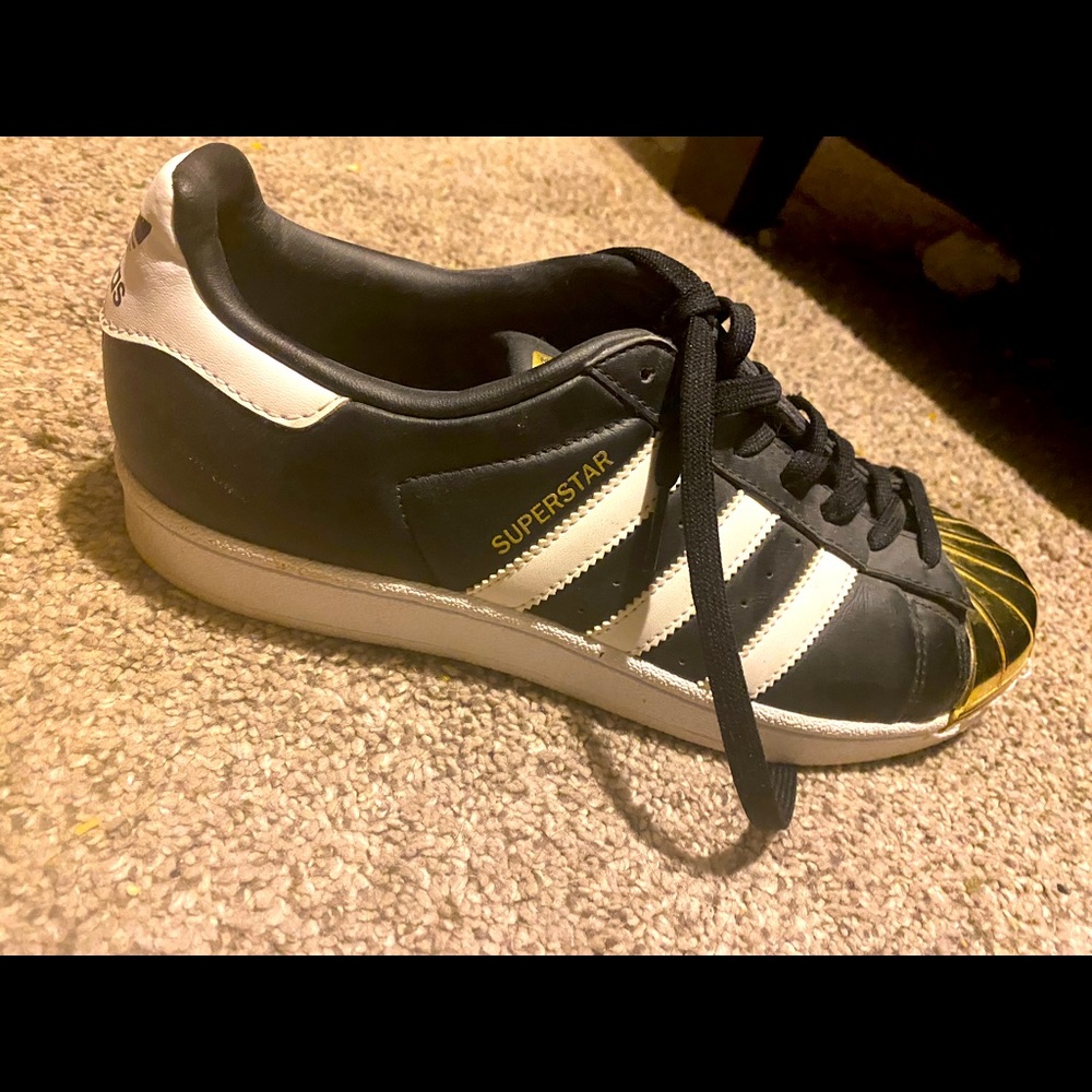 Brand new gold toe Adidas shoe.